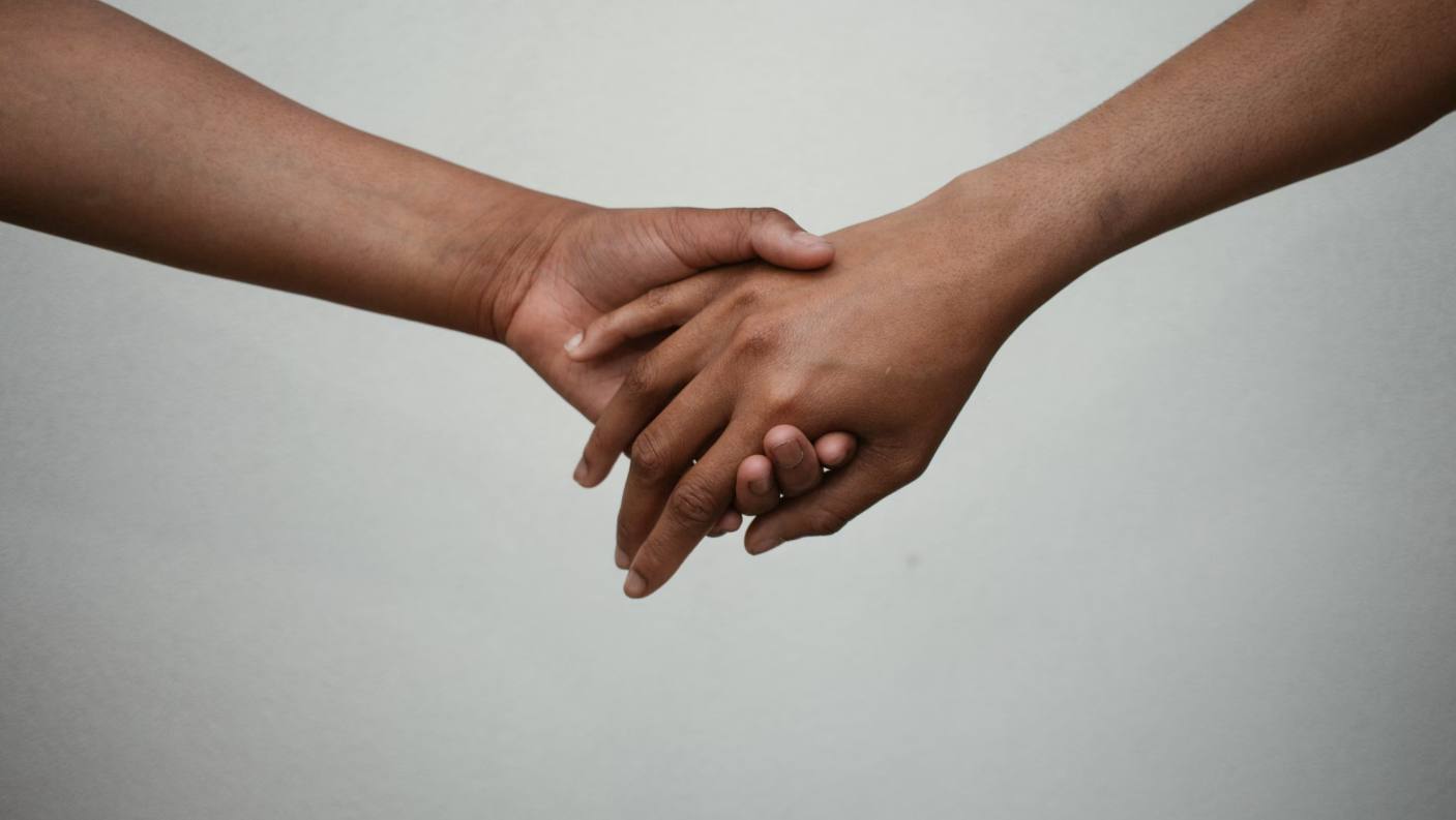 2 people holding hands